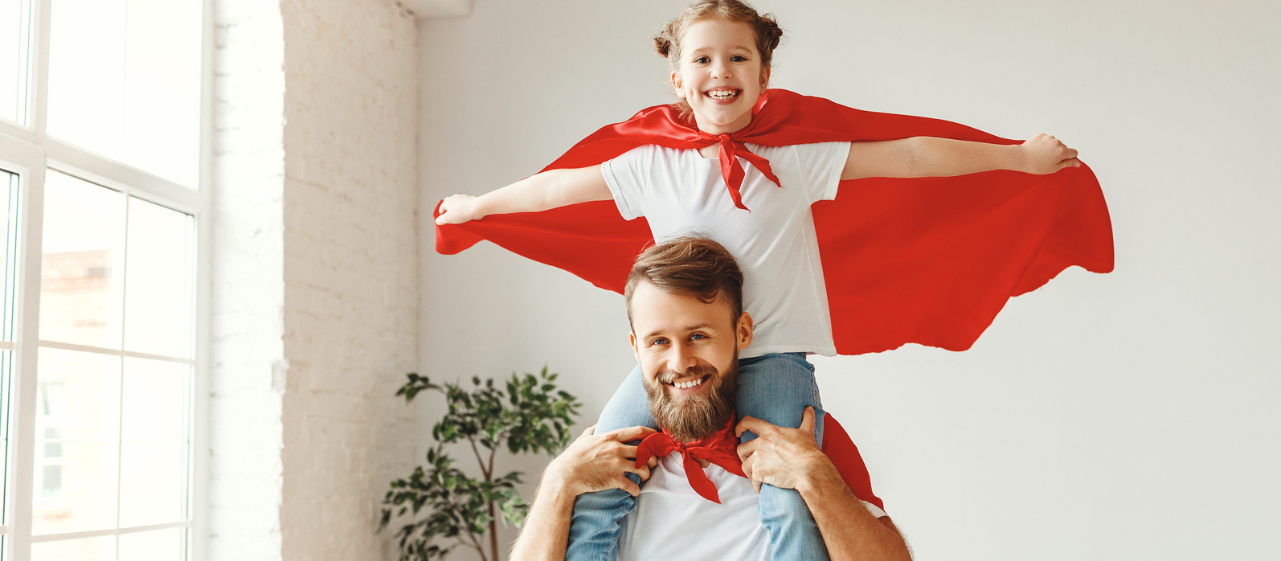 Father and daughter dressed as superheroes